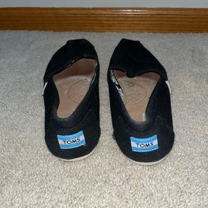 Women’s black slip on Toms